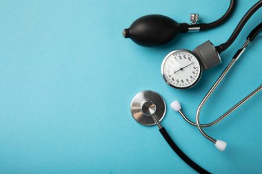 Gray tonometer on a blue background. Medical equipment blood pressure monitor. Healthcare. Place for text. Medicine concept. The concept of cardiology.