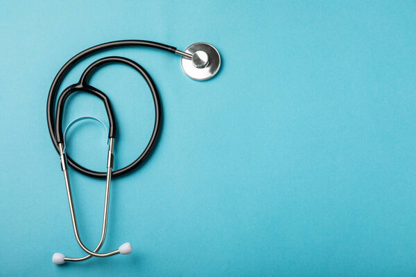 Black tonometer on a blue background. Medical equipment blood pressure monitor. Healthcare. Place for text. Medicine concept. The concept of cardiology.