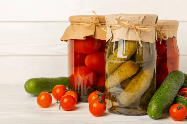 酢漬け野菜の瓶 キュウリとトマトの素朴な木製の背景に — ストック写真