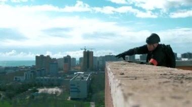 Rescuer down on a rope from the roof of a multistory building gear industrial mountaineer