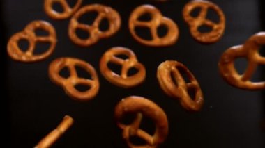 Siyah arka planda çıtır tuzlu krakerler. Süper yavaş çekim