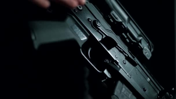 Man Camouflage Black Background Removes Rifle Safety Lock — Stock Video