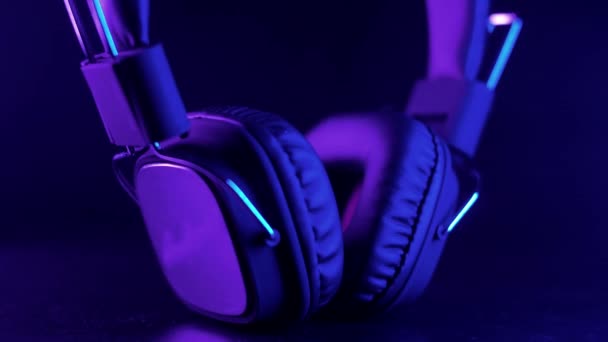 工作室耳机在一个美丽的紫色动态灯 后续行动 — 图库视频影像
