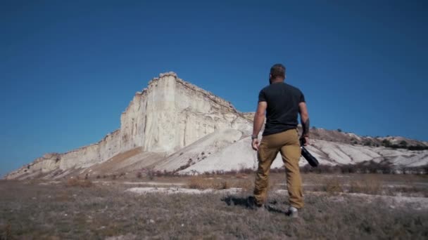 Hombre Fotógrafo Viajes Camina Hacia Cañón Sosteniendo Una Cámara Profesional — Vídeo de stock