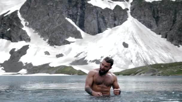 髭を生やした男が高地の氷河湖で叫び — ストック動画