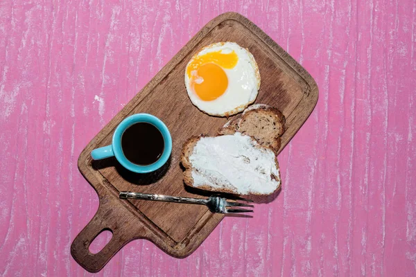盘子里的煎蛋面包片在切菜板上有浓缩咖啡 与粉红背景隔离 顶视图 早餐食品和饮料概念 — 图库照片