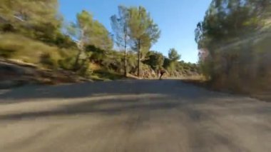 Man riding a longboard on sunset in a road. Skateboard travel. Longboarding.