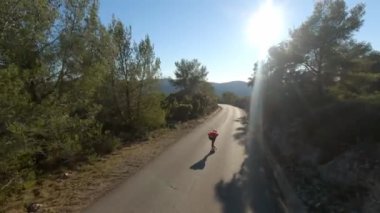 Man riding a longboard sunset in a road. Downhill Longboarding 4k drone skate