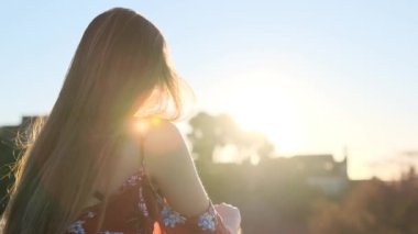 Woman admires the sunset in Parc Guell Barcelona sunrise with pretty young girl