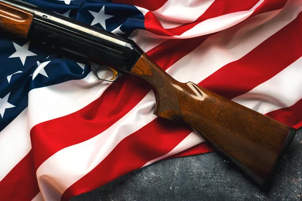 Shotgun over American Flag. Gun control and rights