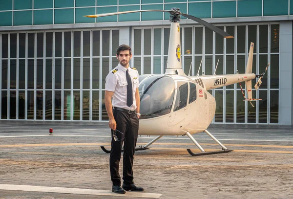 young man in suit and airplane standing on the background of the airport