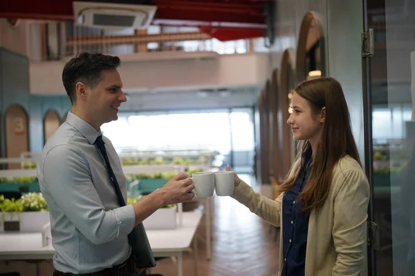 Young man consulting his business partner at meeting in office