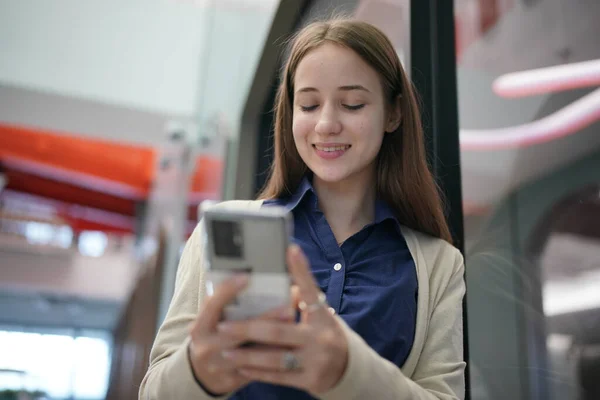 Young attractive female using a mobile phone for social media and using new online 5G technology app