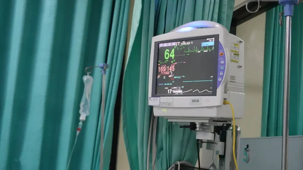 Medical vital signs monitor instrument in a hospital. This health care device displays and monitors heart rate and oxygen levels in hospital patients