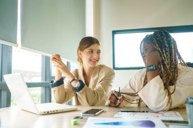 Image of young business people discussing document in paperwork data on desk at meeting