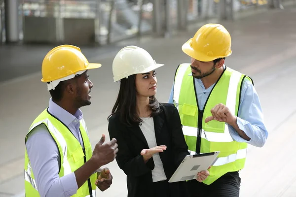 group of engineers and female worker discussing new project