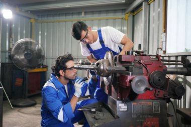 Workers changing and repair part of wheels at the car service