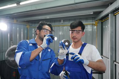 Workers changing and repair part of wheels at the car service