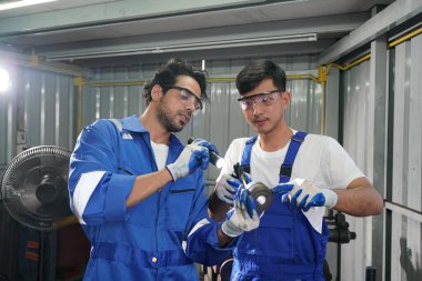 Workers changing and repair part of wheels at the car service