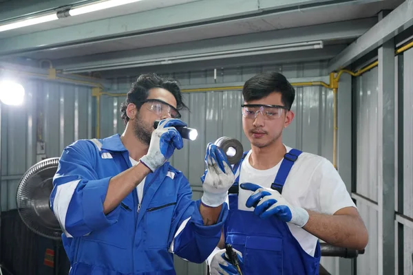 Workers changing and repair part of wheels at the car service