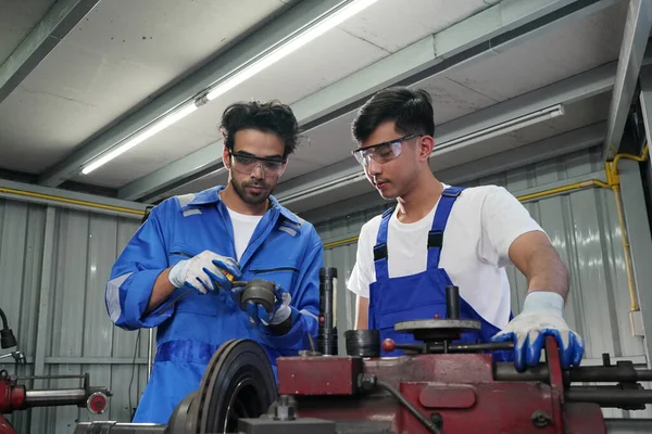 Workers changing and repair part of wheels at the car service