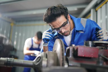 Workers changing and repair part of wheels at the car service