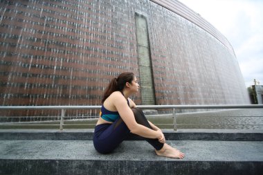 Young sporty attractive woman practicing yoga, doing yoga exercise, Beautiful young woman practicing yoga on wooden terrace.
