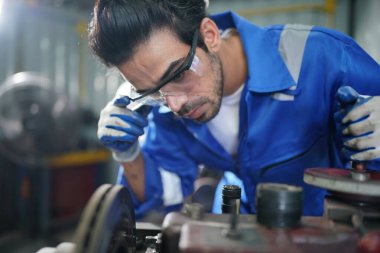 Worker changing and repair part of wheels at the car service