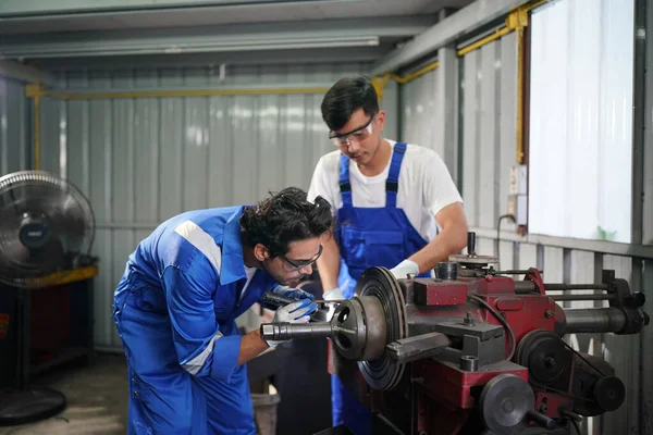 Workers changing and repair part of wheels at the car service