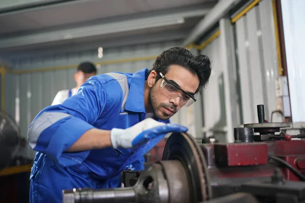 Worker changing and repair part of wheels at the car service