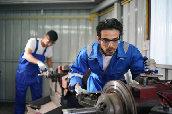 Workers changing and repair part of wheels at the car service