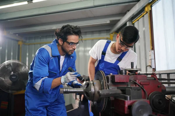 Workers changing and repair part of wheels at the car service