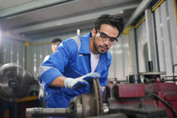 Worker changing and repair part of wheels at the car service