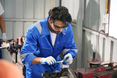 Worker changing and repair part of wheels at the car service