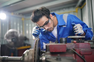 Worker changing and repair part of wheels at the car service
