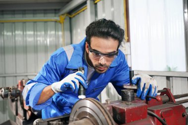 Worker changing and repair part of wheels at the car service