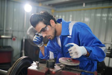 Worker changing and repair part of wheels at the car service