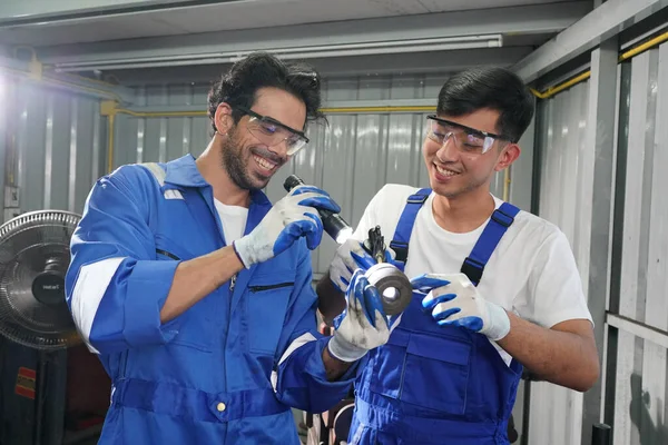 Workers changing and repair part of wheels at the car service