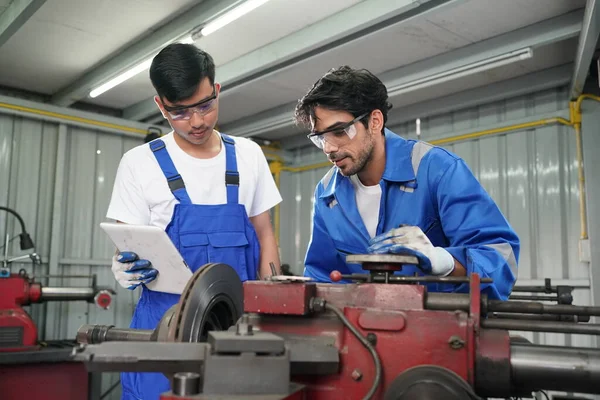 Workers changing and repair part of wheels at the car service