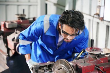 Workers changing and repair part of wheels at the car service