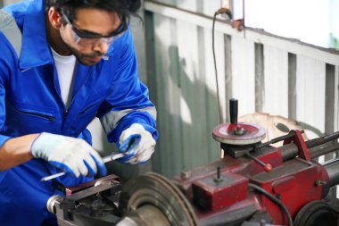 Worker changing and repair part of wheels at the car service