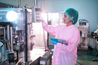 Asian worker labor working in food and beverage for drink industry factory with hygiene work fruit juice production line inspector staff. Inspect Beverage Process Check Production Line Conveyor