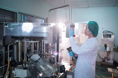 Asian worker labor working in food and beverage for drink industry factory with hygiene work fruit juice production line inspector staff. Inspect Beverage Process Check Production Line Conveyor