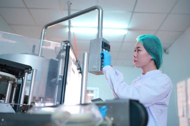 Asian worker labor working in food and beverage for drink industry factory with hygiene work fruit juice production line inspector staff. Inspect Beverage Process Check Production Line Conveyor