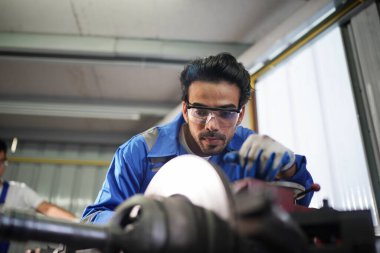 Workers changing and repair part of wheels at the car service