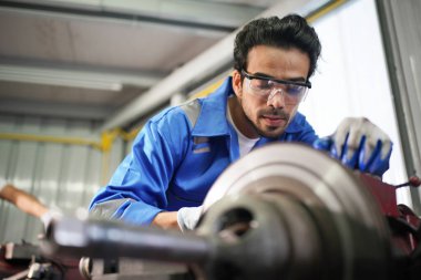 Workers changing and repair part of wheels at the car service