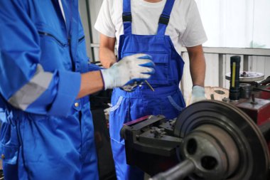 Workers changing and repair part of wheels at the car service