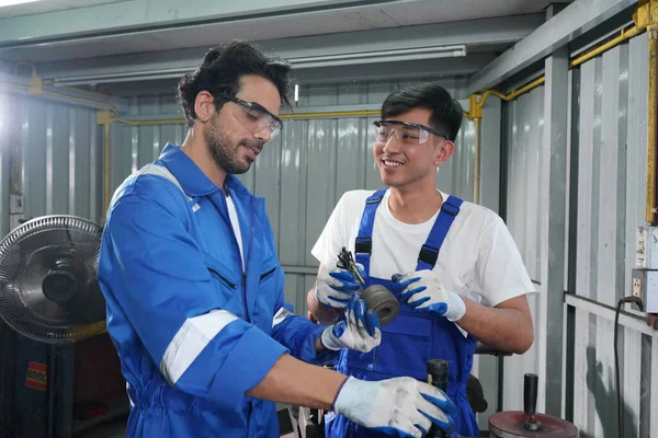 Workers changing and repair part of wheels at the car service