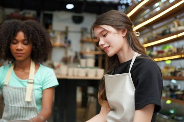 Young  girls  hand potters making clay vase in pottery workshop, Business owner.  clipart