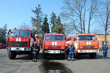 Firemen standing near fire trucks before training. April 5, 2019. Forestry of Sviatoshyn district, Kievskaya oblast, Ukraine